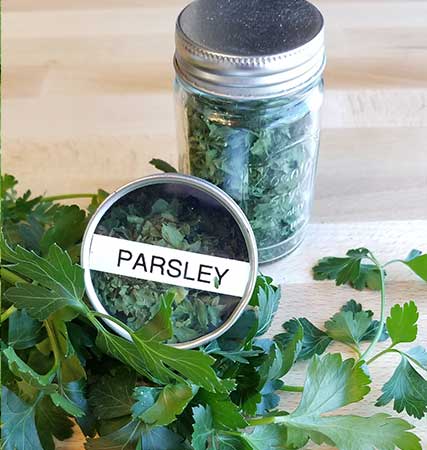 Dehydrated parsley stored in containers, dry parsley, dried herbs, save herbs