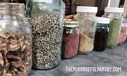 Canning jars in a row full of food storage items from the pantry. 13+ ways to re-purpose canning jars for the home.