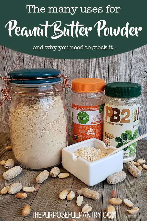 Glass jar full of peanut butter powder and dish with powder on wooden background with peanuts strewn around