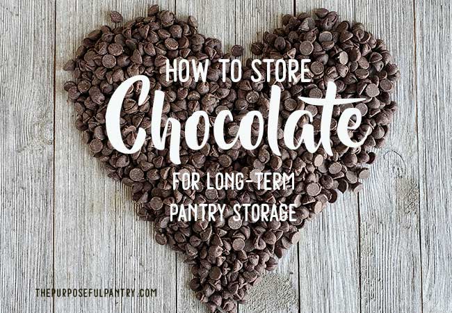 Chocolate chips formed in the shape of a heart on a wooden background with the text How to Store chocolate