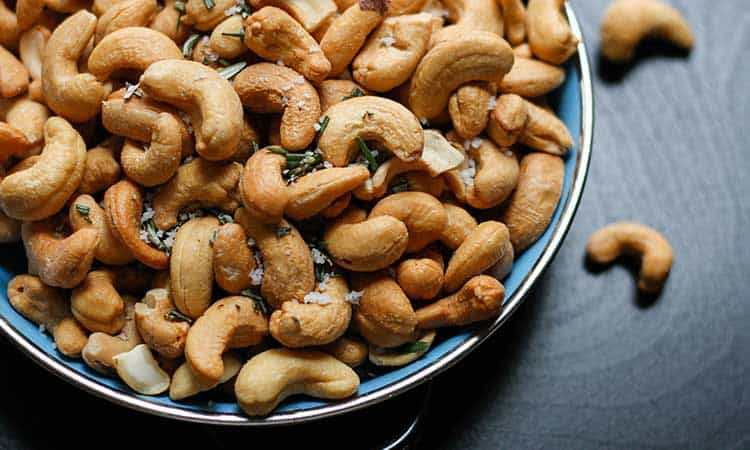 blue bowl full of cashew nuts for storing nuts.
