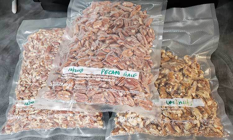 3 bags of bulk nuts witha food saver vacuum sealer for storing nuts