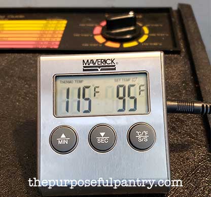 oven thermometer in open Excalibur Dehydrator to test dehydrator temperature