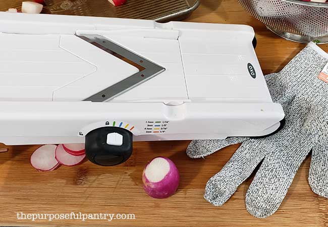 Oxo Good Grips Mandoline and protective cutting glove with radish slices to dehydrate radishes