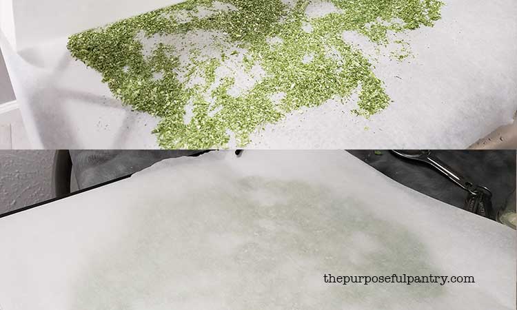 Flat of Excalibur dehydrator tray with powdered green onions and covered with parchment paper