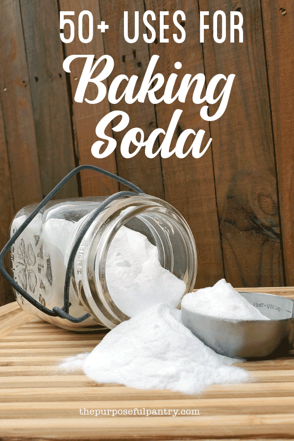 Jar of baking soda on a cutting board wit a measuring spoon with text 50 ways to use baking soda
