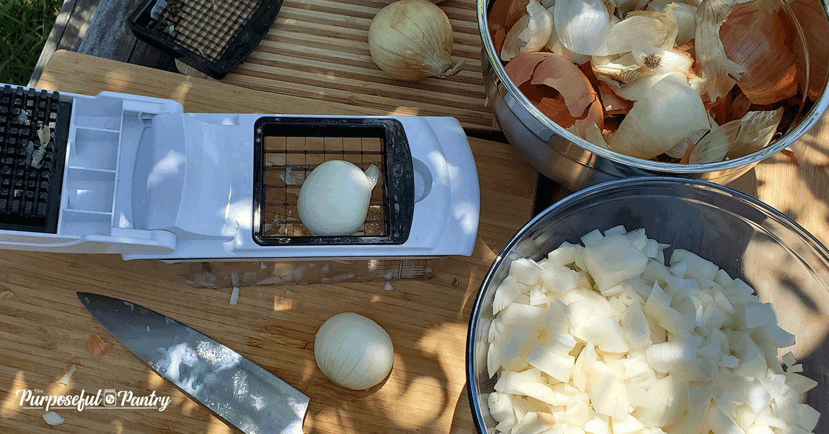 Prep table of chopped onions and onion skins to dehydrate onions.