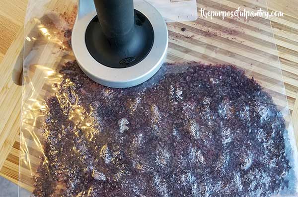Bag of dehydrated blackberries with a meat tenderizer to pulverize them into powder