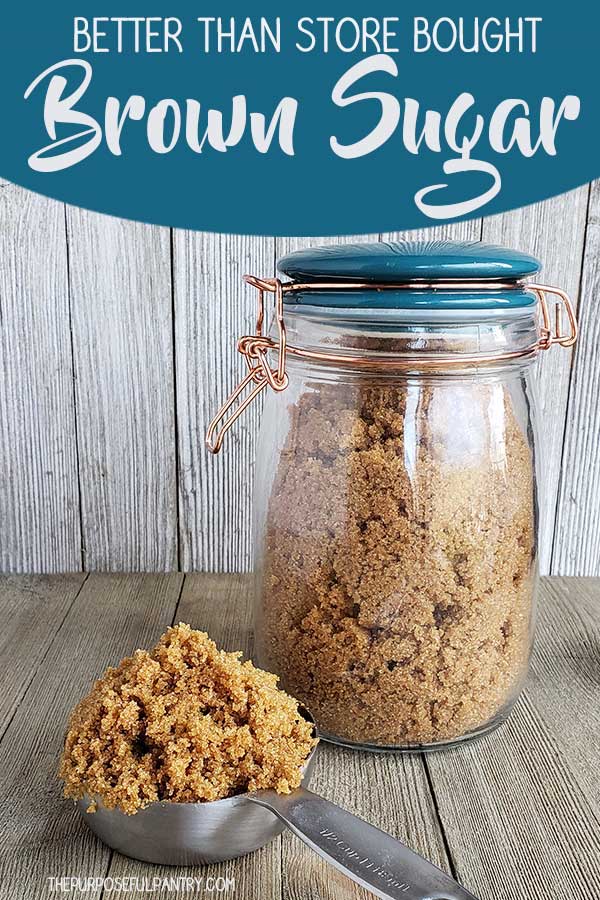 A jar of homemade brown sugar with a measuring cup of brown sugar heaped inside on a wooden surface