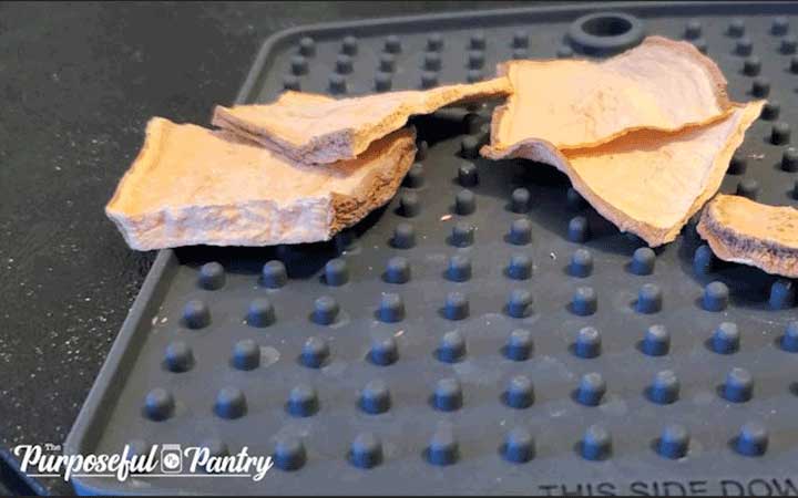 dried sweet potato slices on a silicone mat