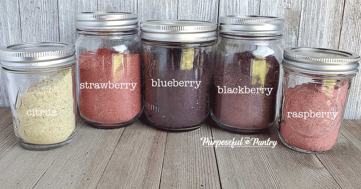 Mason jars of various dehydrated fruit powders in rainbow colors