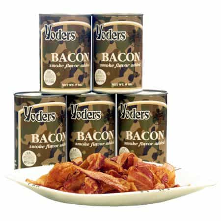 Cans of Yoders canned bacon in a stack with a dish of the bacon in front of them.