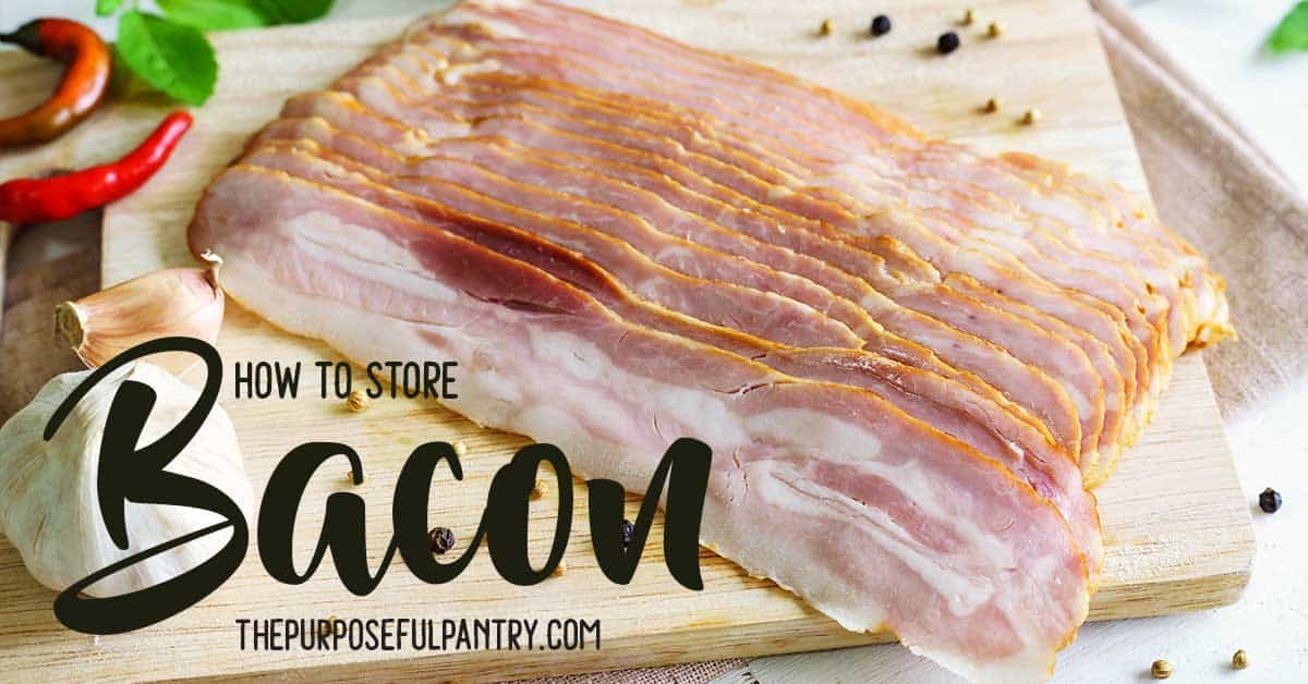 slab of bacon on a wooden cutting board surrounded by herbs and spices