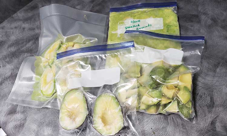avocados in plastic storage bags - halved, chunked and creamed.