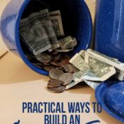 Blue metal jar holding cash and coins