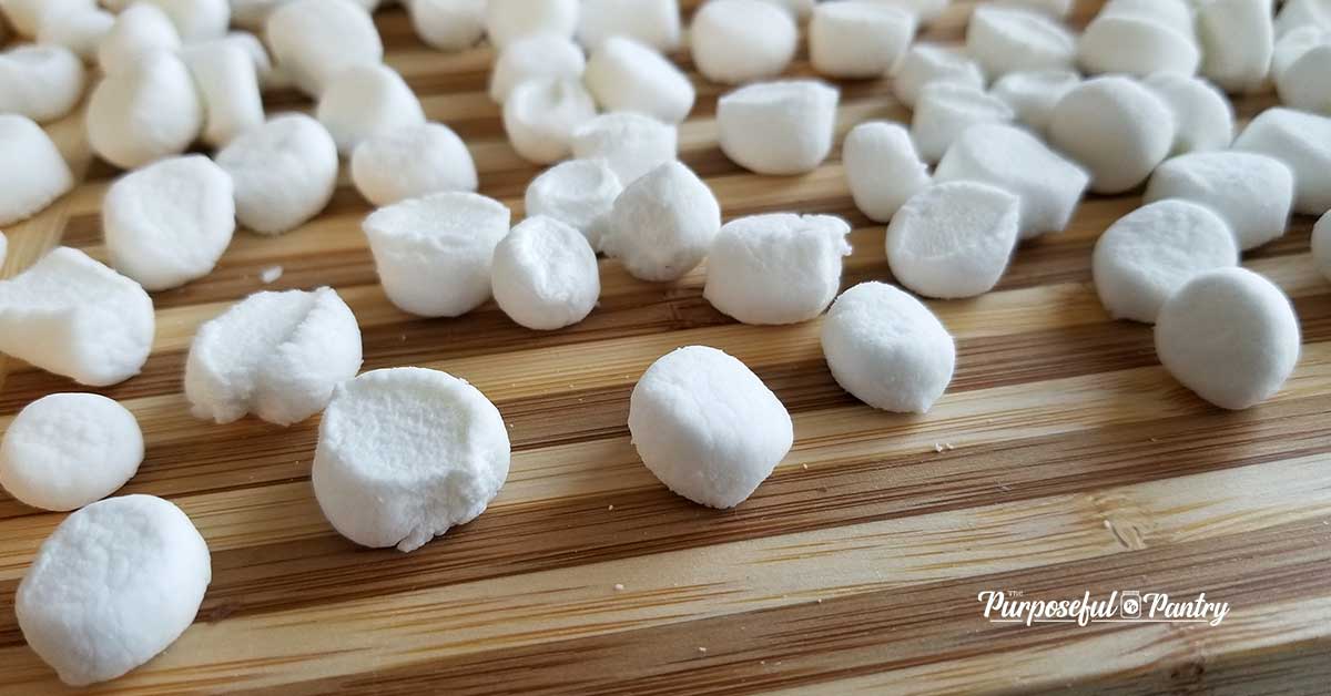 Dehydrated marshmallows on a wooden cutting surface
