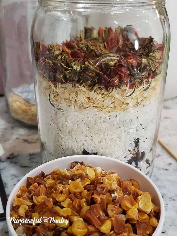 Taco soup in a jar with a cup of dehydrated corn
