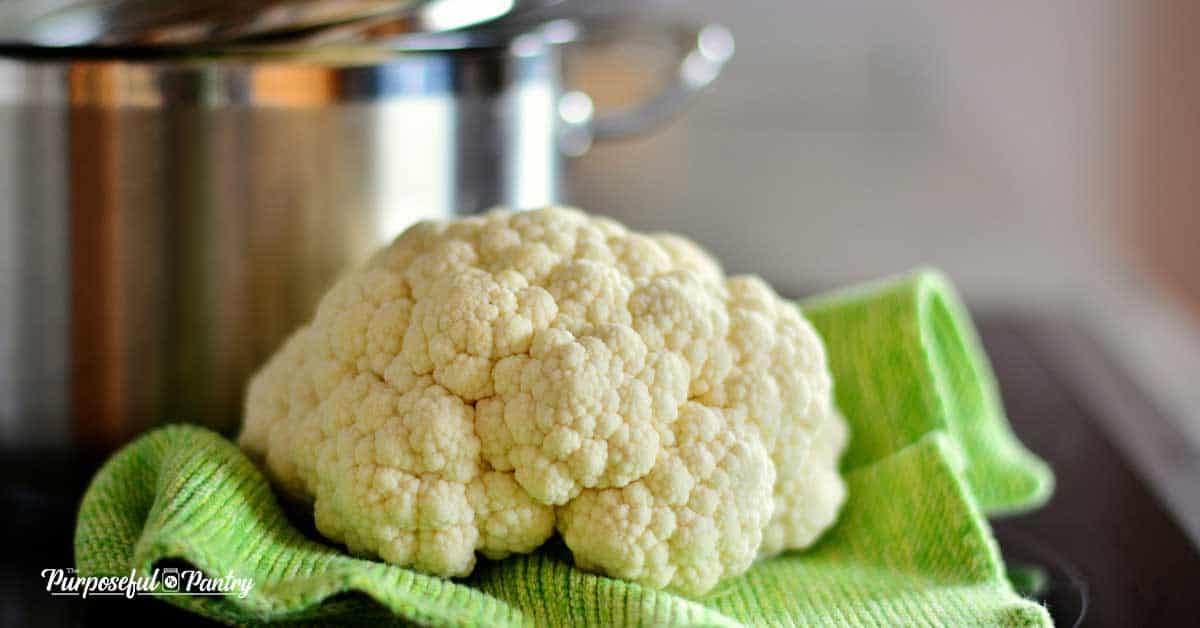 cauliflower on a green cloth in front of a stockpot