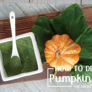 Pumpkin leaf and green pumpkin powder on a wooden surface with small pumpkin and serving dish