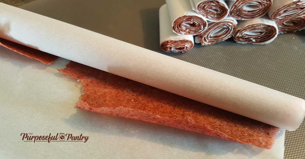 Rolling strawberry banana fruitleather to make rolups