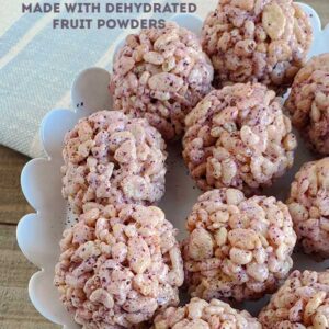 Rice Krispies Treat Balls on a white serving dish set on a wooden background