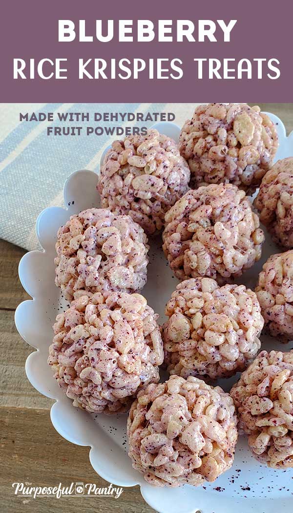 Rice Krispies Treat Balls on a white serving dish set on a wooden background