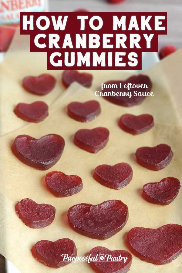 heart-shaped cranberry gummies made from canned, jellied, cranberry sauce on a parchment background.