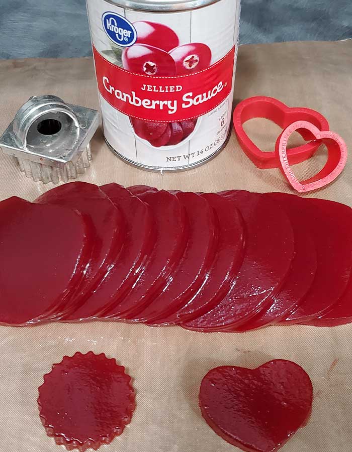 Cookie cutters, can of jellied cranberry sauce, and sliced sauce with a few cutouts