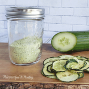 Jar of powdered cucumber, a fresh English cucumber and a pile of flavored, dehydrated cucumber chips