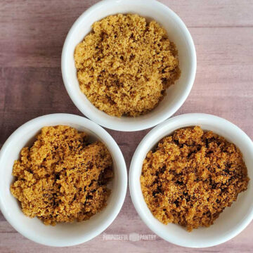 Brown sugar, light medium and dark, in white bowls.