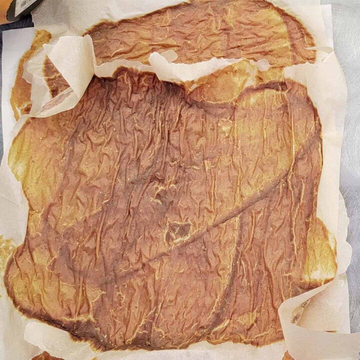 Over dried pumpkin puree on parchment paper
