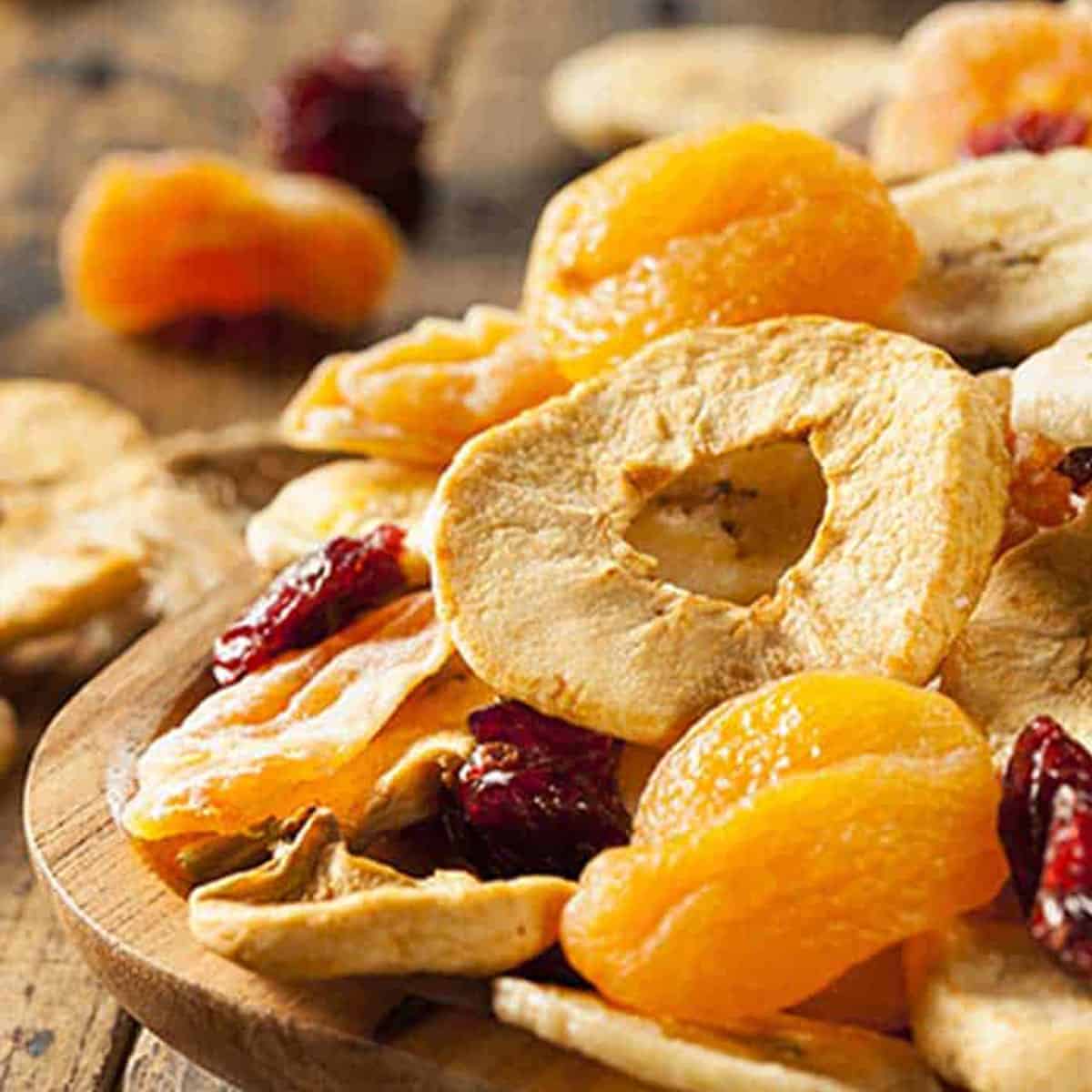 An assortment of dried fruits on a wooden table