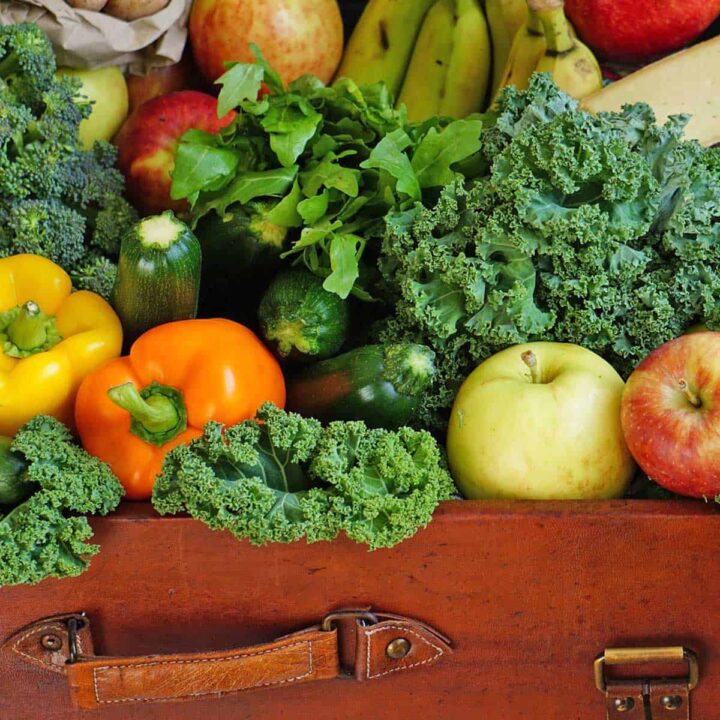 Fruits and vegetables in a suitcase for a post on how to dehydrate produce