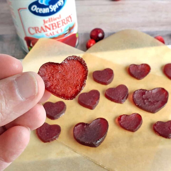 Heart-shaped cranberry sauce gummies (jellies) on parchment paper