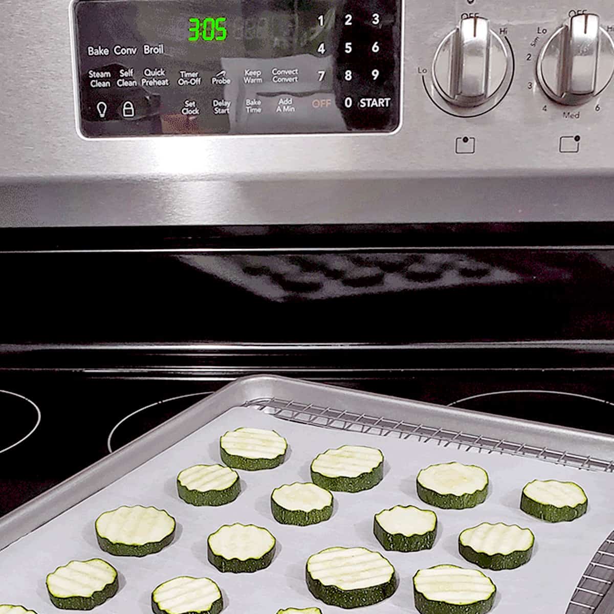 Frigidair oven with a tray of zucchini on it, ready to be dried in the oven