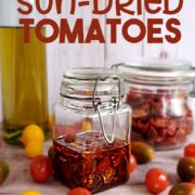 Jar of homemade sun-dried tomatoes with fresh tomatoes, olive oil and dried tomatoes