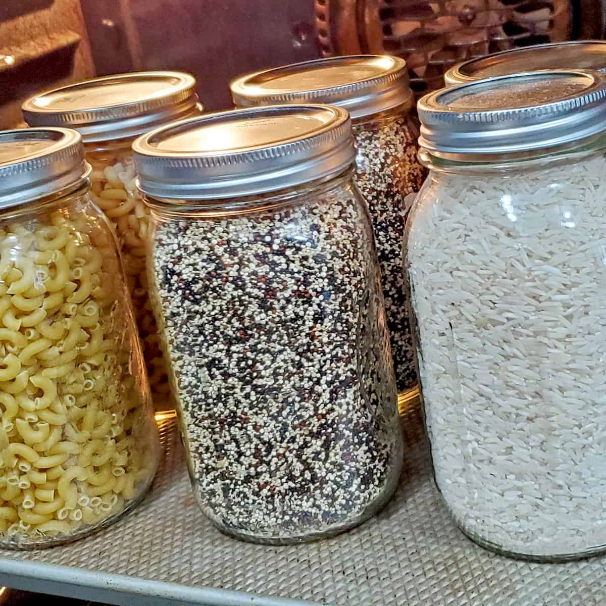 Macaroni, Quinoa and Rice inside mason jars being canned in the oven