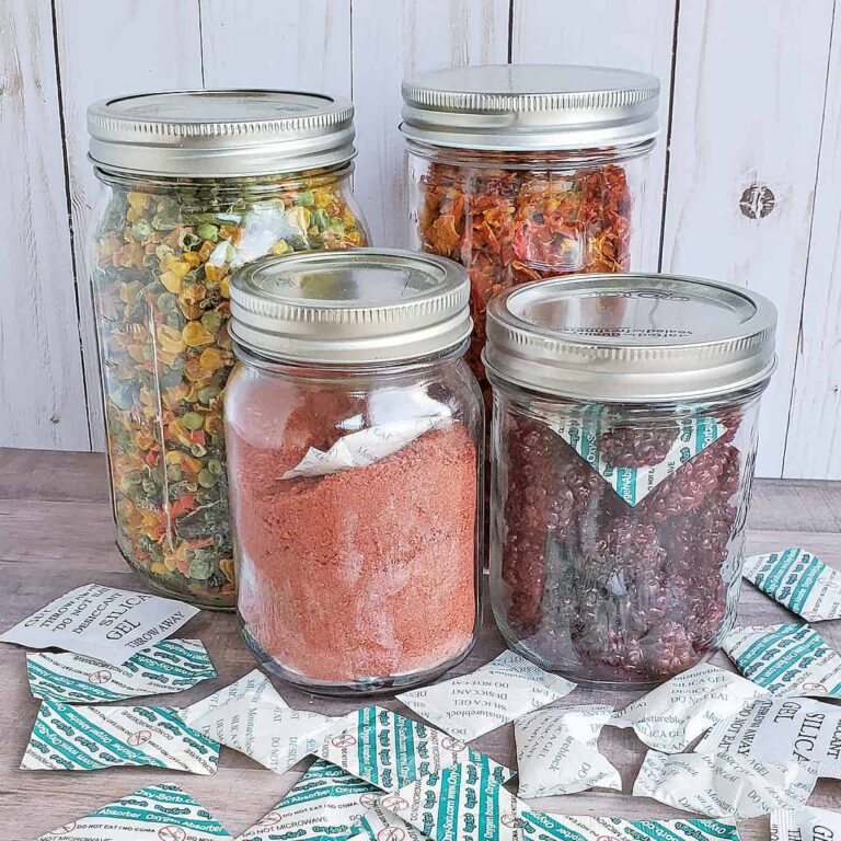 Canning jars full of dehydrated foods showing the best way of storing dehydrating foods