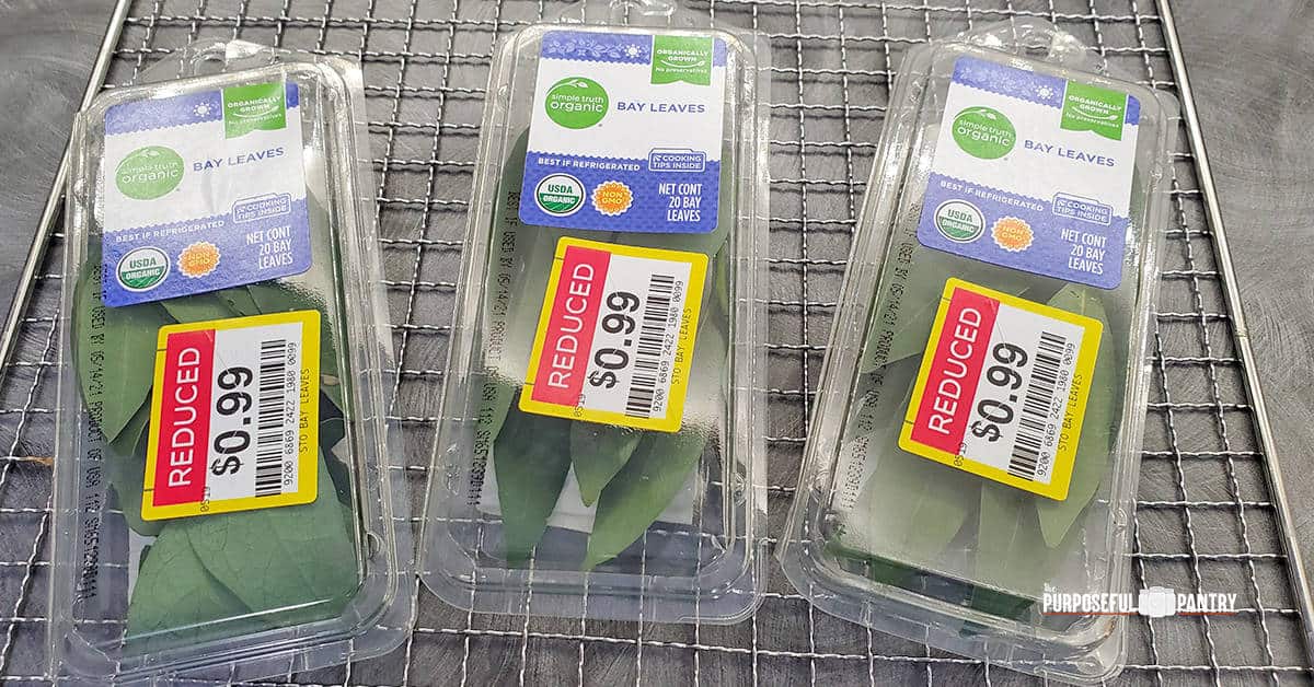 Bay leaves in plastic containers with reduced sales stickers from the grocery store