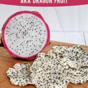 Fresh dragon fruit next to a pile of dehydrated dragon fruit (pitaya) chips on a wooden surface