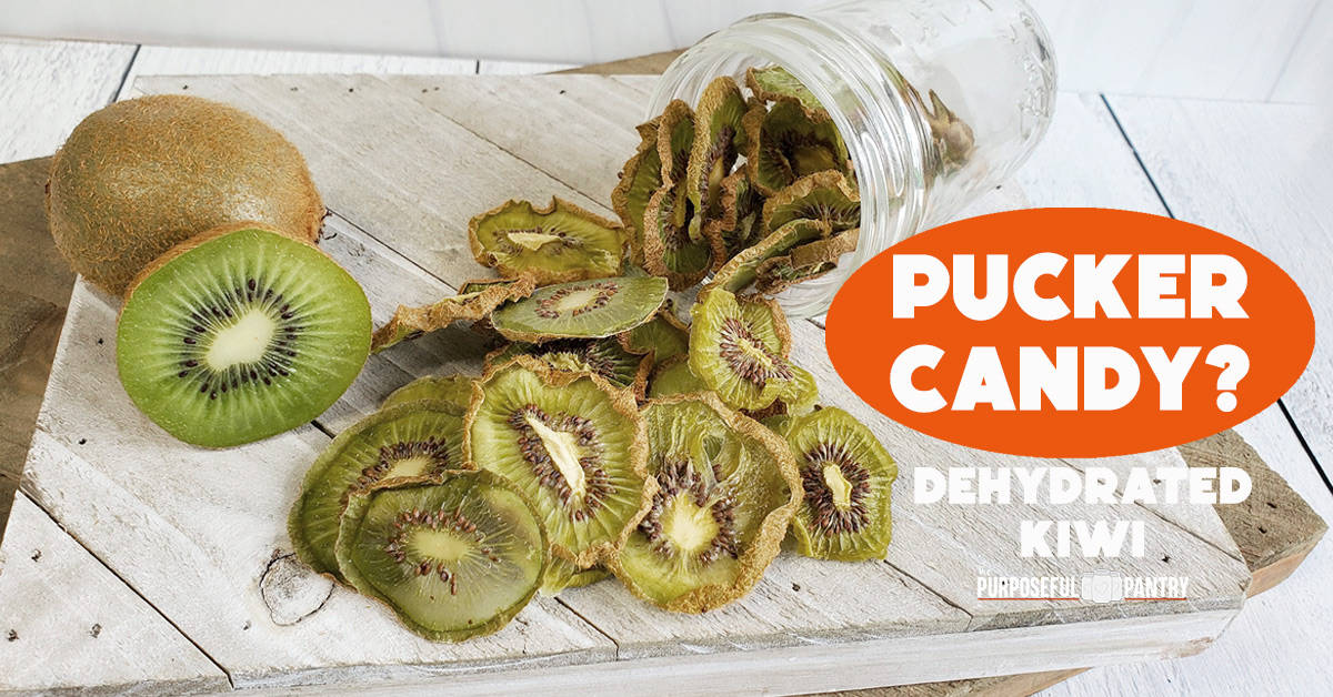 Fresh sliced kiwi with dehydrated kiwi slices falling out of a mason jar onto a white wooden surface