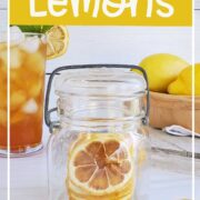 Dried lemon slices in a jar, on the table, and one in a glass of iced tea.