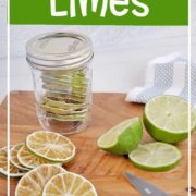 Dehydrated limes in a jar, on a cutting board with freshly cut limes