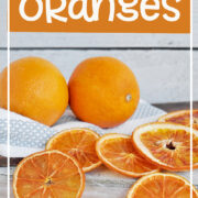 Fresh oranges with sliced dried oranges across the surface