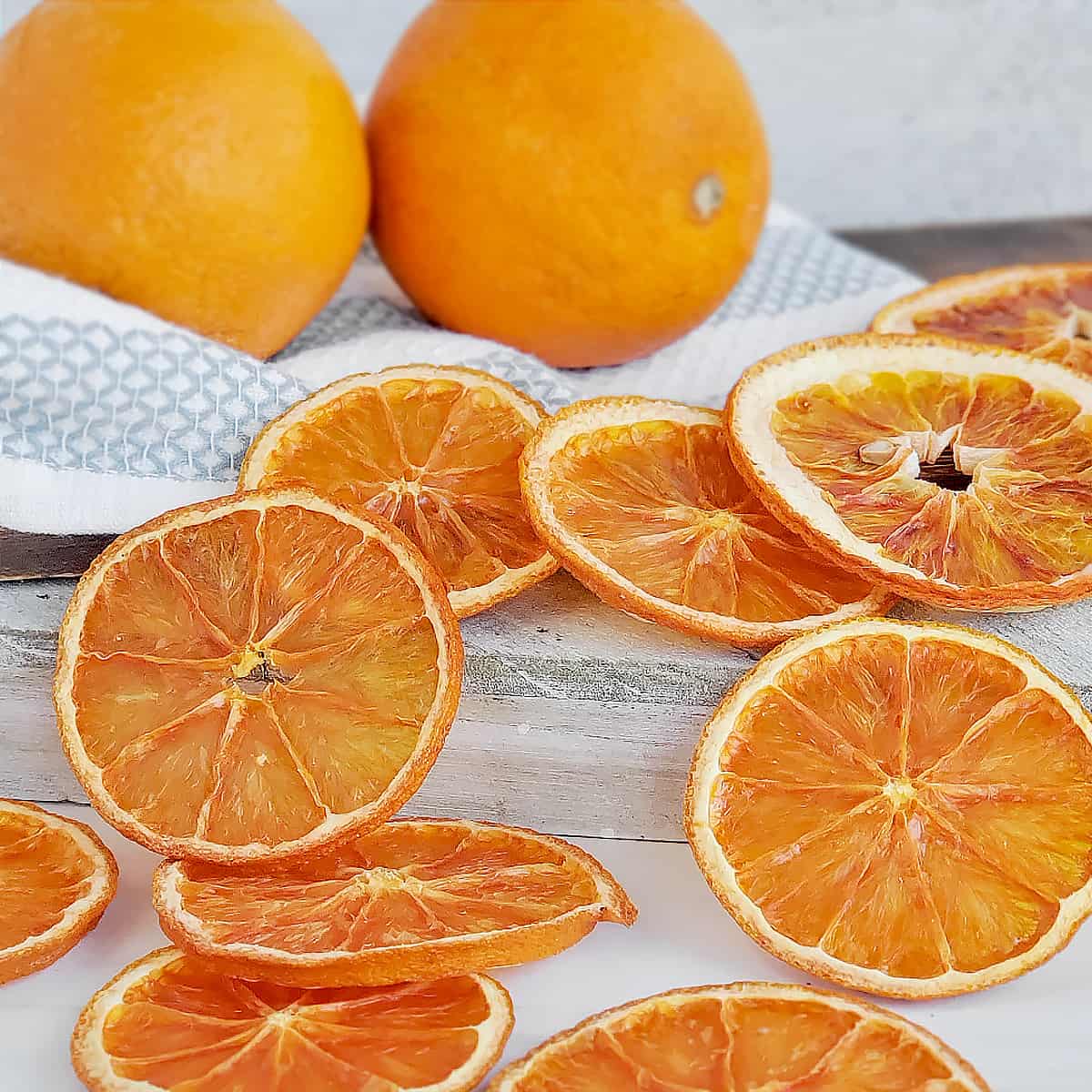 Fresh oranges with sliced dried oranges across the surface