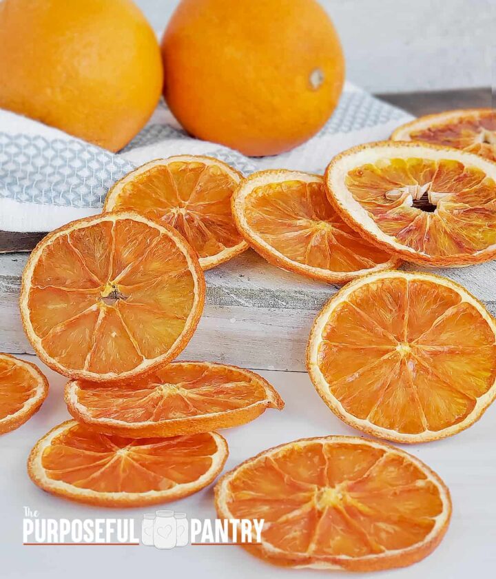 Fresh oranges with sliced dried oranges across the surface