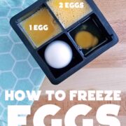 Eggs broken into ice cube compartments for freezing - in different quantities. On a blue cloth and wooden surface