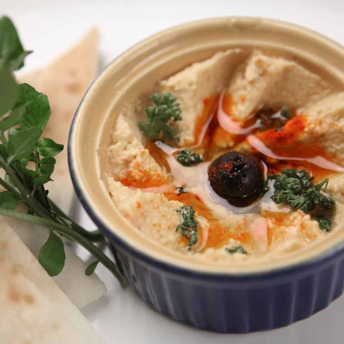 Bowl of hummus with a side of pita bread makes a great snack from your food storage.