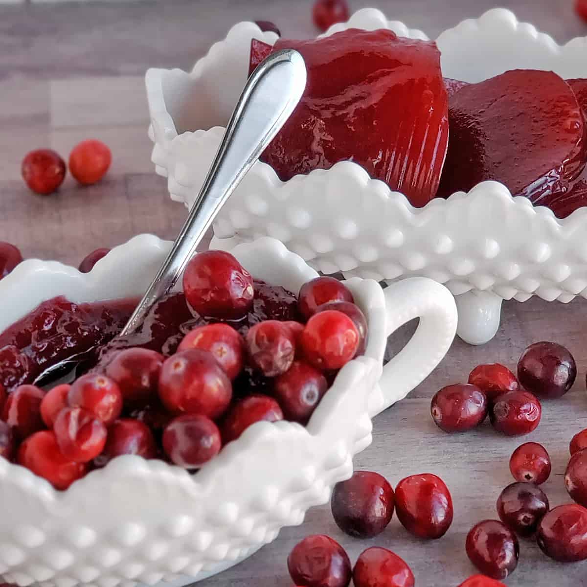 White milk glass serving dishes with cranberry sauce and jellied cranberry sauce