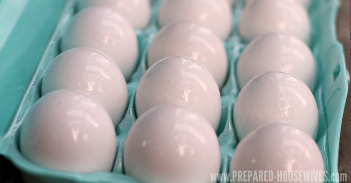 Eggs that have been coated in mineral oil for preservation in a blue egg carton